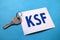 KSF key success factor, text words typography written on paper against blue background, life and business motivational