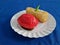 Ku cake and rissoles in a white container on a blue cloth background