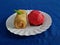 Ku cake and rissoles in a white container on a blue cloth background