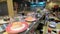 Kuala Lumpur, Malaysia - July 18, 2018 : Dishes of sushi and sashimi rolling on conveyer belt at Sushi King Restaurant