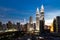 KUALA LUMPUR, MALAYSIA - JULY 23, 2016: View of the Petronas Twin Towers and KL Tower at KLCC City Center during dusk hour. The