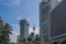 Kuala Lumpur Tower in betwen buildings and coconut trees