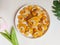 kue kering kacang mede or cashew cookies. made from butter, flour, egg and topped with cashew nut. served on white plate.