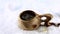 Kuksa. A tea in a Finnish wooden cup. Traditional Finnish wooden cup in the snow. Boiling water jet. The hand puts the