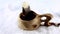 Kuksa. A tea in a Finnish wooden cup. Traditional Finnish wooden cup in the snow. Boiling water jet. The hand removes a