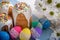 Kulich, traditional Russian Ukrainian Easter cake with icing and colored eggs with lace ribbon on white wooden background