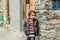 Kullu, Himachal Pradesh, India - April 01, 2019 : Portrait himachali girl near her house on the street in Himalayan village