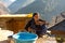Kullu, Himachal Pradesh, India - December 21, 2018 : Photo of himalayan woman washing her face in mountains
