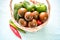 Kumato (brown) tomatoes in basket, closeup