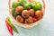 Kumato (brown) tomatoes in basket, closeup