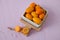 Kumquat in a cup on a pink background, sour fruit