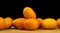 Kumquat, fresh citrus fruits on a wooden board on a black backgroud. Cumquat, healthy food, raw diet concept. Copy space