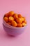 Kumquat fruits on a pink background