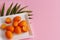 Kumquat fruits on a pink background
