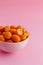 Kumquat fruits on a pink background