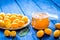 Kumquat on plate and jam in jar at wooden table