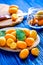 Kumquat on plate at wooden table