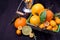 Kumquats, mandarins, lemons and limes against dark background