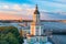 Kunstkamera at sunset on a summer evening and in the background Rostral columns on the Spit of Vasilyevsky Island and the Peter