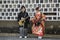 KURASHIKI, JAPAN - MARCH 31, 2019: Young man and a girl in kimono dress imitate playing on electric guitars