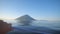 Kuril whale watching cruise ship passenger looking at humback whale near mountains with binoculars and camera exploring