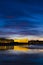 Kursaal auditorium illuminated at night is reflected in the beach of Zurriola, city of San Sebastian