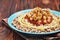 Kushari - Egyptian dish of lentils, rice, pasta, chickpeas with tomato sauce and crispy onions