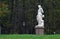 Kuskovo park in Moscow. A woman sculpture. Green trees.