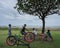KUTA/INDONESIA-JANUARY 14 2018: Some Balinese children along with their bicycles, were sitting in a tree near the beach, chatting