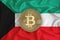 Kuwait flag, bitcoin gold coin on flag background. The concept of blockchain, bitcoin, currency decentralization in the country.