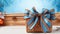 Kwanzaa Gift Box With Blue Bow And Snowflakes On Bamboo