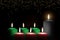 Kwanzaa holiday background with candle light of seven candle sticks in black, green, red symbolising 7 principles of African