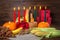 Kwanzaa holiday concept with candles red, black and green, gift box, pumpkins, ears of wheat, grapes, corns, banana, bowl and
