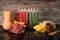 Kwanzaa holiday concept with traditional lit candles, pumpkin, corns, grapes, banana, bowl and of wheat with reflection on black