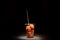 Kwek â€“ Kwek / Tokneneng â€“ a Filipino  tempura-like street food in plastic cup with stick in  black isolated background
