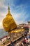 Kyaikhtiyo, Myanmar - December 27, 2018: The Golden Rock or Kyaikhtiyo pagoda in Myanmar with pilgrims.