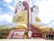 Kyaikpun pagoda against blue sky, Four Seated Buddha shrine at Kyaikpun Pagoda in Bago, Burma