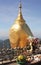 Kyaiktiyo pagoda or Golden rock pagoda, a holy Buddhist site in Myanmar with offerings in foreground