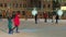 Kyiv, Ukraine, 09 January 2021: Christmas holidays, Podyl, People in defocus skating on rink in winter of evening city.