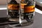 KYIV, UKRAINE - APRIL 03, 2020: Close up of two 200 ml glass bottles of Malawi gin staying in line on a dark background