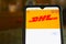 Kyiv, Ukraine - April 18, 2021: DHL tracking shipment app on s7, close to a parcel post.