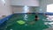 Kyiv, Ukraine - August 29, 2020: Cute little boys child kicking feet in swimming costume wear swimming goggles use floating board