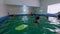 Kyiv, Ukraine - August 29, 2020: Cute little boys child kicking feet in swimming costume wear swimming goggles use floating board