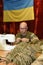Kyiv,Ukraine -December.24,2022: War of Russia against Ukraine. Volunteer sews a camouflage sniper suit on sewing machine