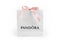 KYIV, UKRAINE - FEBRUARY 11, 2021: Pandora paper bag with pink bow. Famous for its bracelets with charms brand is a manufacturer