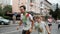 Kyiv/Ukraine - June 2, 2019 - Brother holding hand of his young sister stained in colorful fluorescent holi paint and running on s