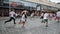 Kyiv/Ukraine - June 2, 2019 - Happy charming little children in white t-shirts intensive running in city center at paint festival