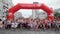 Kyiv/Ukraine - June 2, 2019 - Happy smiling little boys and girls crossing starting line and inflatable arch and starting to run i