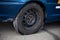 Kyiv, Ukraine - June 21, 2020: Wheel of a car with an old tire. Obsolete, damaged tire. Torn and full of holes. Tire fitting,
