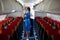 Kyiv, Ukraine - June 27, 2020: A flight attendant and a stewardess in a medical mask in the cabin of a Windrose airline prepares